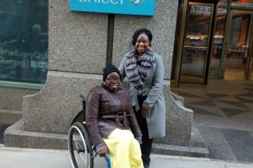 Toyin in front of the UNICEF building in New York